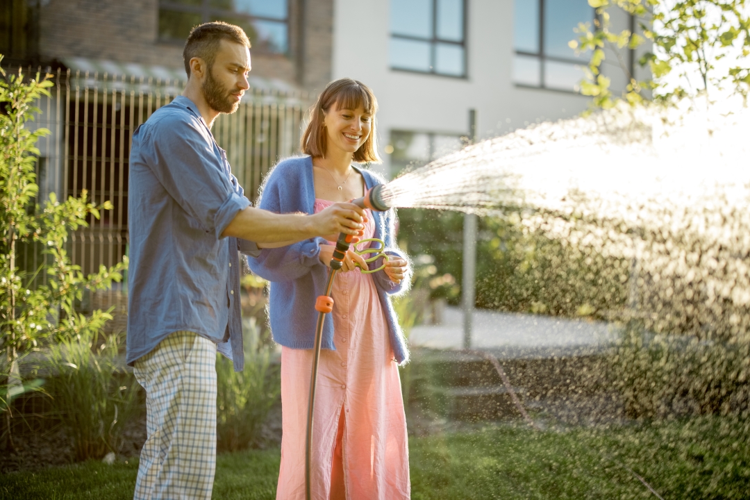 Couple watering by hand